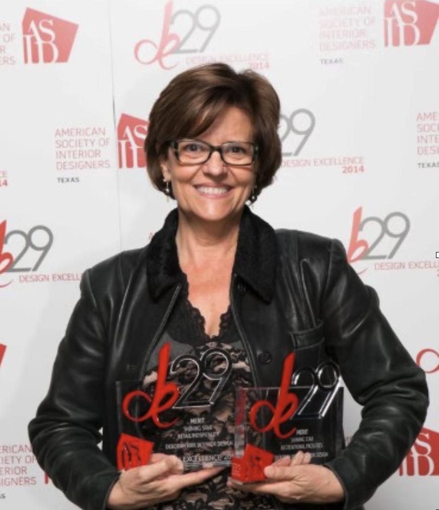 Deborah Kirk holding two 2014 ASID Design Excellence Shining Star awards